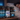 Three supplement bottles labeled 'Leucine', 'L-Glycine', and 'Magnesium Glycinate' on a nightstand with a person sleeping in the background.
