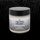 Jar of Primal Wellness magnesium Arnica Tallow Balm on a black background
