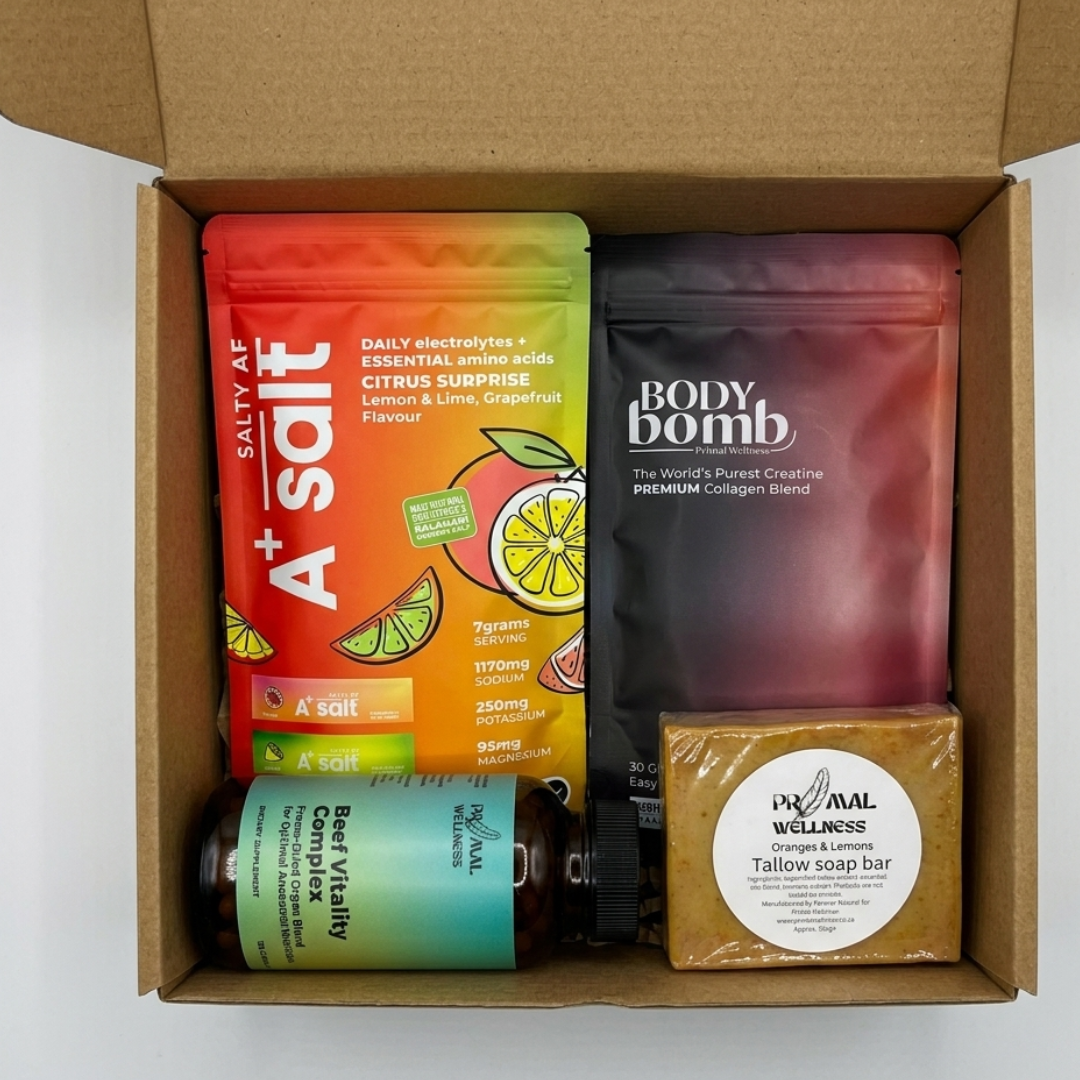 Box containing A+Salt packet, Body Bomb package, and Primal Wellness tallow bar on a white background