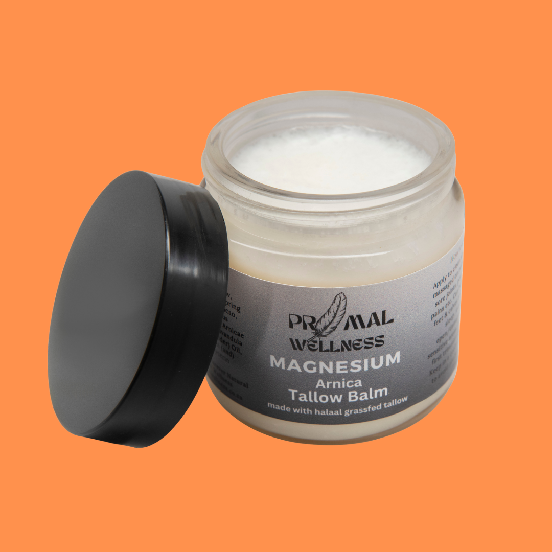 Jar of Primal Wellness Arnica Tallow Balm on an orange background