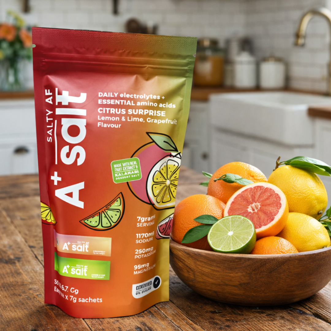 SALTY AF A+ Salt packet with a bowl of citrus fruits on a kitchen counter.