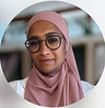 Woman wearing a pink hijab and glasses with a blurred background